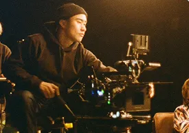 Director behind a cinema camera on a film set